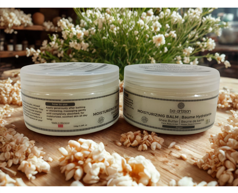 “Be Artisan unscented moisturising balm with shea butter and argan oil in 150g jars, natural fragrance-free skincare displayed with flowers on a wooden surface.”