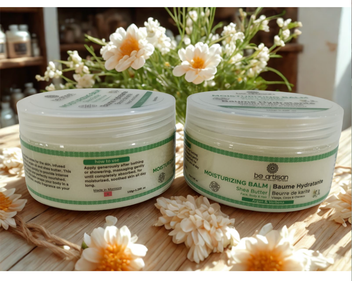 “Be Artisan natural moisturising balm with shea butter, in 150g jar, hydrating skincare cream on a wooden surface with flowers.”