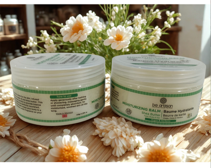 “Be Artisan natural moisturising balm with shea butter, in 150g jar, hydrating skincare cream on a wooden surface with flowers.”
