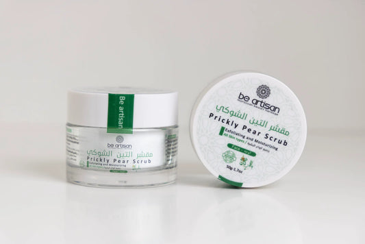 “Be Artisan Prickly Pear Scrub jar on a wooden surface, natural skincare exfoliating product with cactus seed oil.”