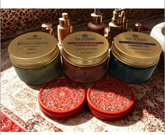 “Be Artisan Nila Scrub jar with gold lid on mosaic Moroccan surface, blue exfoliating scrub suitable for all skin types.”